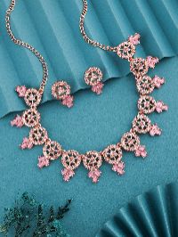 Elegant rose gold necklace and earring set adorned with White AD