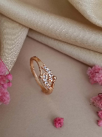 Elegant Rose Gold Ring Featuring a Polished and Gemstone-Adorned Crossover Design