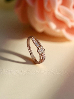 Elegant Rose Gold Ring Featuring a Clover Motif and Sparkling Gemstone Strips